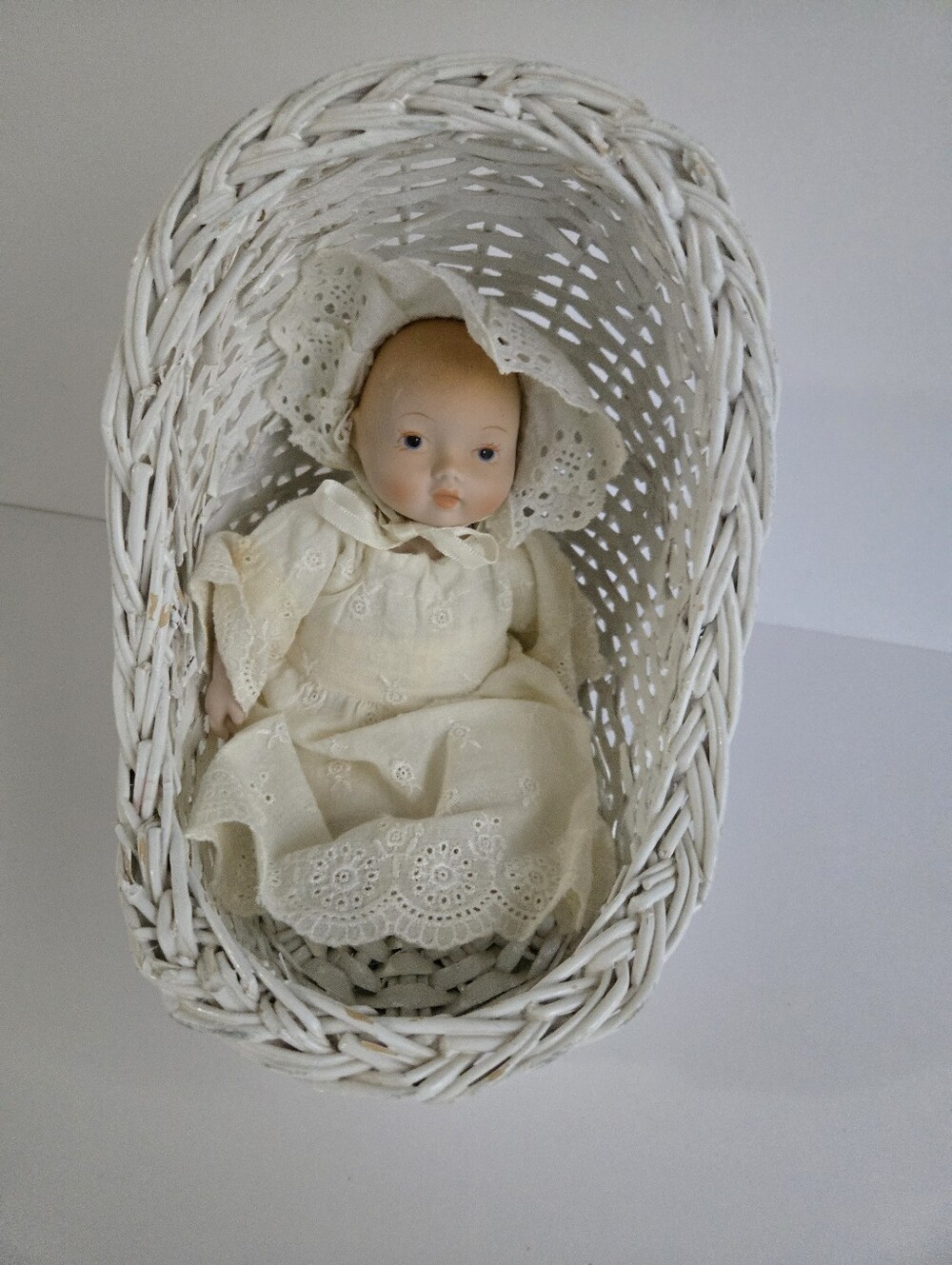 Porcelain Doll In Cradle
